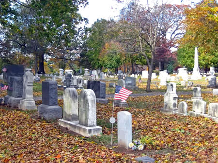 Graves and Headstones in a Cemetery in Autumnの写真素材