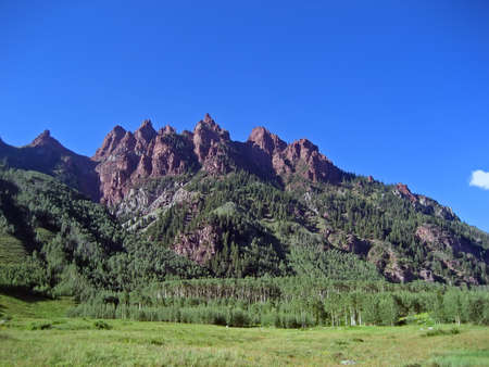 Jagged reddish-brown Rocky Mountain peaks in summertime.の写真素材