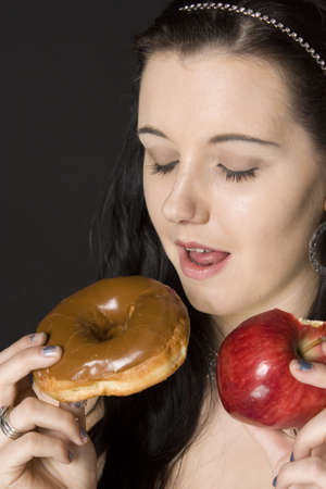 Choices, apple or cakeの写真素材