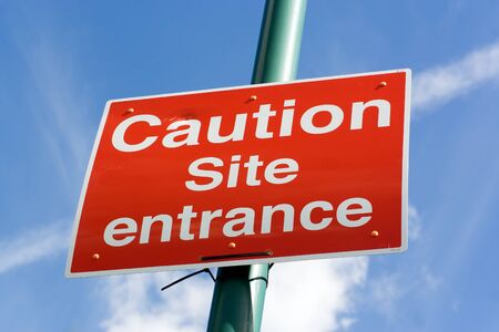 large red caution road sign for work site entrance