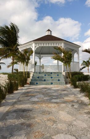 wooden white wedding gazebo with stone pathの写真素材