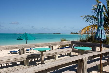 wooden platform with bench seats overlooking tropical beach