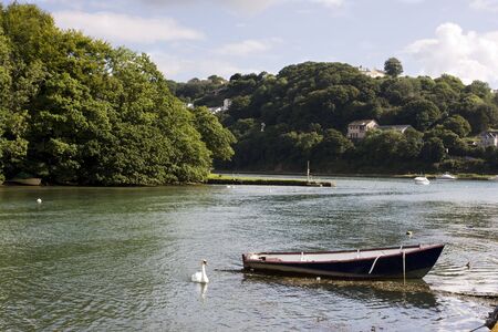 open fishing boat moored in a river in summerの写真素材