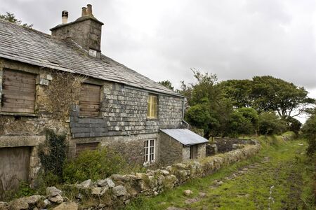 boarded up and abandoned cottage on the moorsの写真素材