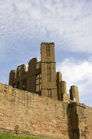 ruins of castle tower behind a boundry wallの写真素材