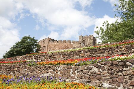 castle overlooking summer flower display in a parkの写真素材