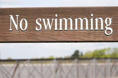 no swimming wooden sign with white lettersの写真素材