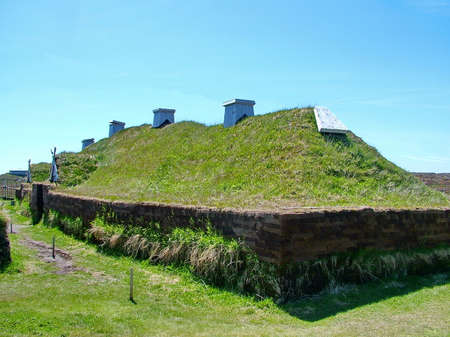 Newfoundland, CA: L'Anse aux Meadows on June 24, 2011. A re-creation of a Viking timber-and-sod-longhouse. L'Anse aux Meadows is the first and only known viking archaeological site in North America.のeditorial素材