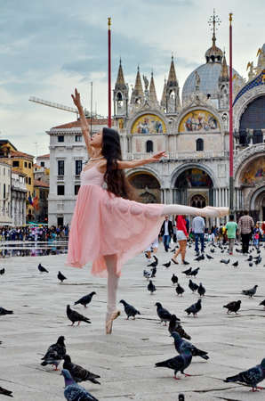 VENICE, ITALY - September 23, 2015: Unknown ballerina dances in flooded Piazza San Marco in Venice, Italyのeditorial素材