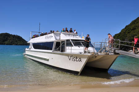 Abel Tasman National Park, South Island, New Zealand, November 11, 2016: A water taxi transports tourists along the coastal hiking trail in Abel Tasman National Park.のeditorial素材