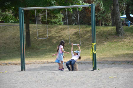 Ontario, Canada, July 8, 2020: Children play on a closed Toronto public playground during the Covid-19 Pandemic.  Ontario closed all public playgrounds in March 2020 to stop the spread of the virus.のeditorial素材