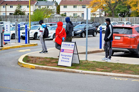 Scarborough, Ontario, Canada, September 29, 2020: People wait in line for a Covid-19 test at the...