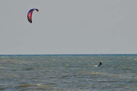 Lake Ontario, Ontario, Canada, November 20, 2020: Kite surfer rides waves on Lake Ontario on a cold November day.のeditorial素材