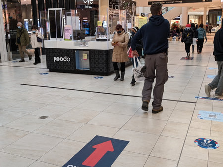Markham, Ontario, Canada, Dec. 10, 2020: Shoppers wearing face masks shop at the Markville Shopping Centre during the Pandemic. This mall moved to curbside pickup & delivery under the Grey-Lockdown.のeditorial素材