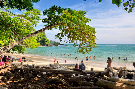 Puntarenas Province, Costa Rica, March 17, 2018: People on the white sandy beach at Manuel Antonio National Park in Costa Rica.のeditorial素材