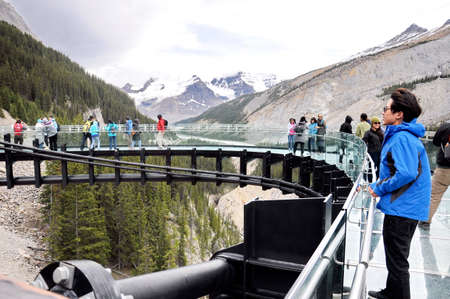 Columbia Icefields, Jasper National Park, Alberta, Canada, July 13, 2019: Tourists enjoying the Skywalk in Jasper National Park during  the summer, with views of the surrounding mountains.のeditorial素材