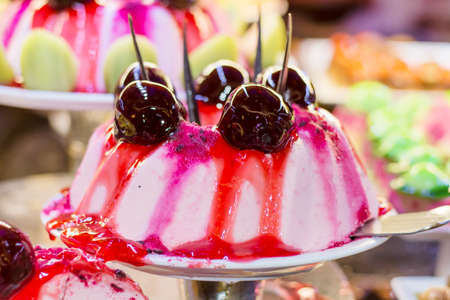 vanilla cream cake with cherry and strawberry glazeの写真素材
