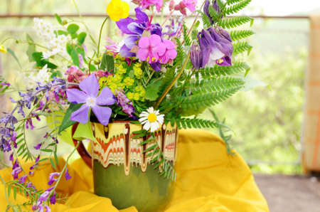 hand made vase with colorful spring wild flowers