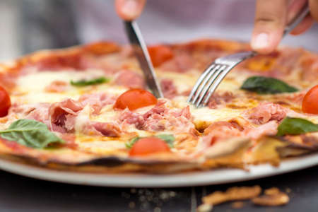 Close up pizza with fork and knifeの写真素材