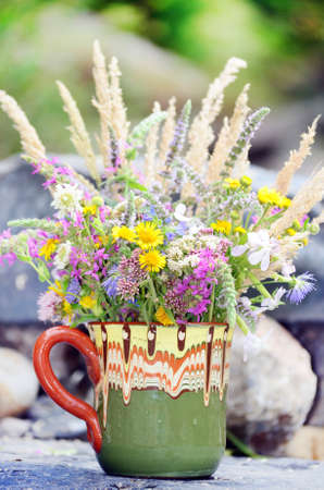 hand made vase with colorful spring wild flowersの写真素材