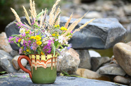 hand made vase with colorful spring wild flowersの写真素材
