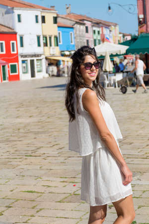 beautiful tourist woman with white dress walking in Burano ,Italyの写真素材