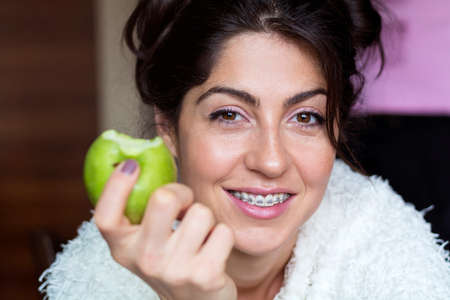 Portrait of a beautiful woman with braces on teeth. Orthodontic Treatment. Dental care Conceptの写真素材