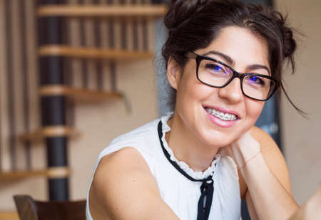 Portrait of a beautiful woman with braces on teeth. Orthodontic Treatment. Dental care Conceptの写真素材