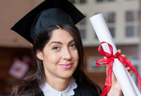 beautiful young woman with diploma in the hand ,college graduationの写真素材