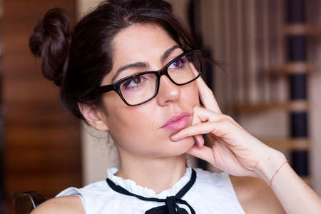 Portrait of beautiful young smiling woman with modern eyeglasses with black frameの写真素材