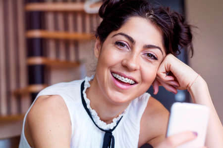 Portrait of a beautiful woman with braces on teeth. Orthodontic Treatment. Dental care Conceptの写真素材