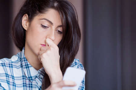Portrait of young sad annoyed woman, receiving bad sms