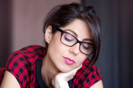 Portrait of beautiful young smiling woman with modern eyeglasses with black frameの写真素材