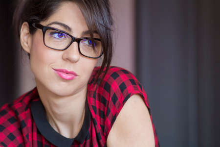 Portrait of beautiful young smiling woman with modern eyeglasses with black frameの写真素材