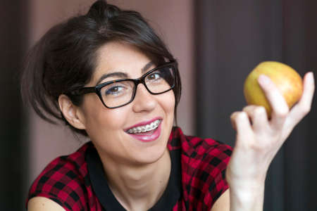 Portrait of a beautiful woman with braces on teeth. Orthodontic Treatment. Dental care Conceptの写真素材