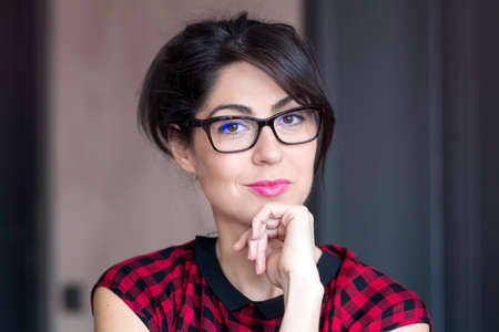 Portrait of beautiful young smiling woman with modern eyeglasses with black frameの写真素材