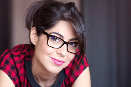 Portrait of beautiful young smiling woman with modern eyeglasses with black frameの写真素材