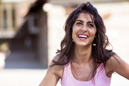 Portrait of a smilling beautiful brunette woman outdoorの写真素材