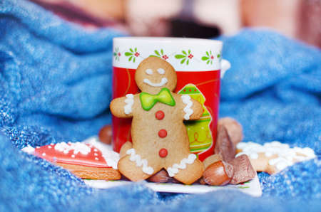 Smiling gingerbread man and christmas red tea cup for christmasの写真素材