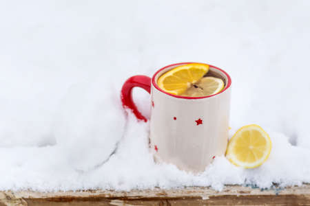 mug of tea in  the snowの写真素材