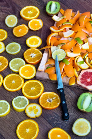 Assorted cut citrus fruits on wooden backgroundの写真素材