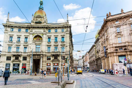 MILAN,ITALY -JUNE 27,2018 :Main  Street with Antique Traditional Buildings in the Downtown of Milan ,Italy.Traffic in  the Fashion Capital of Italyのeditorial素材