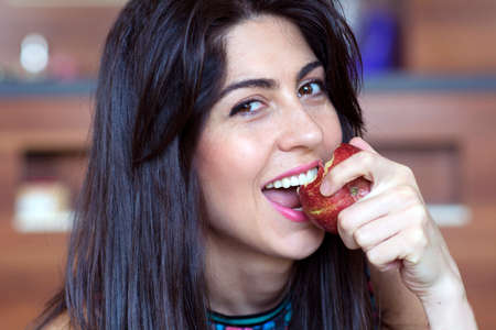 Portrait of a Beautiful Young Woman Eating Red Apple.Healthy Eatingの写真素材