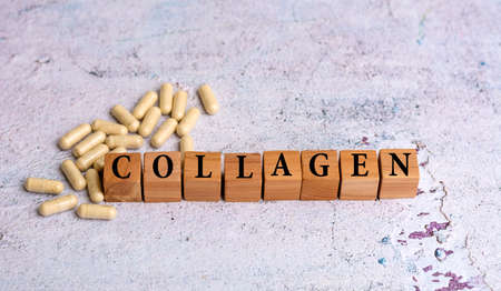 Collagen word written on wooden cubes and pillsの写真素材