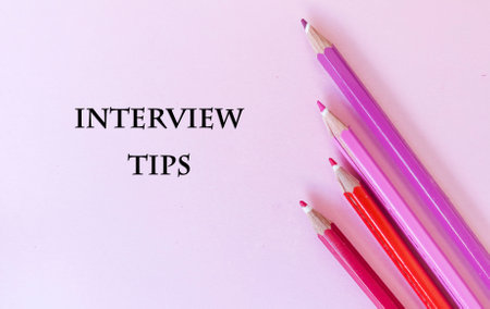 Inscription INTERVIEW TIPS with color pencils on pink background