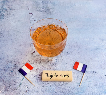 Glass of brandy with flag of France. Selective focus.