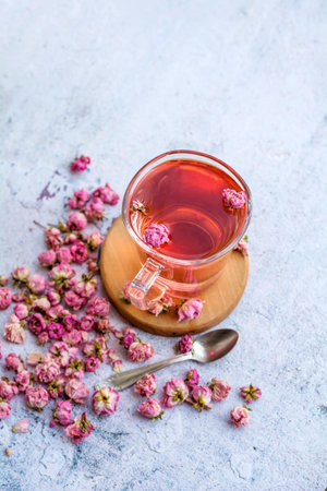 Cup of tea with rose flowers on a light background. Selective focus.の写真素材