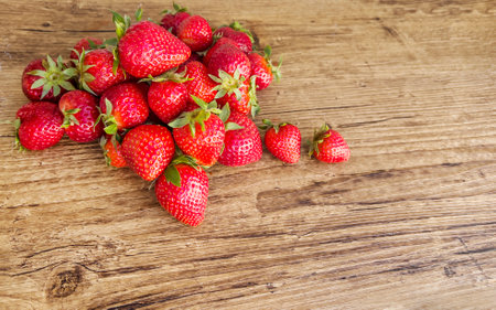 Strawberries on wooden background with copy space. Top view.の写真素材