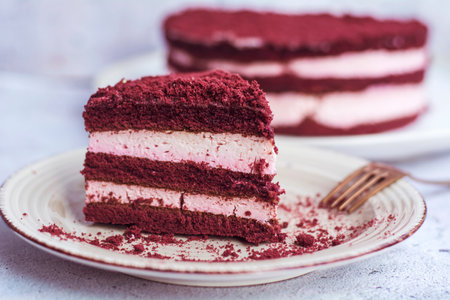 Piece of red velvet cake on white plate, selective focus.