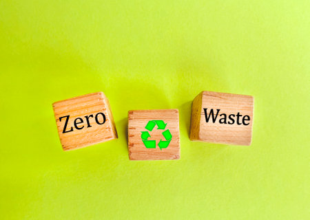 Wooden blocks with the words Zero Waste and Recycle symbol on green backgroundの写真素材